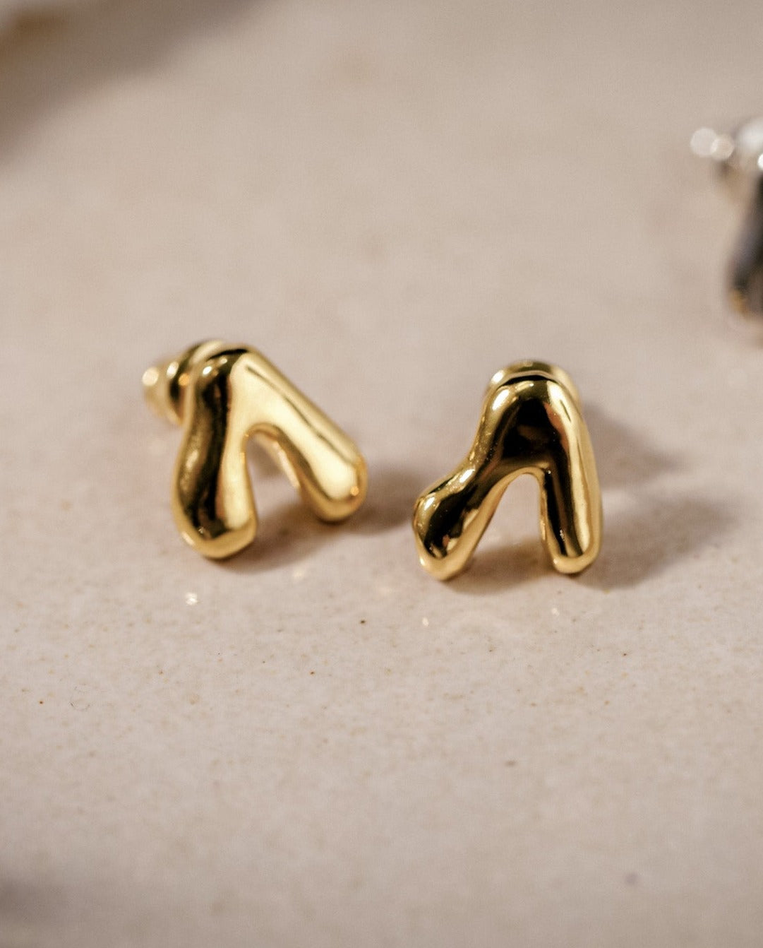 Kharys jewelry organic shaped flow stud earrings in 18k gold vermeil.